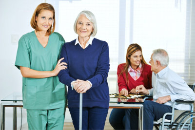 caregiver and senior woman are smiling