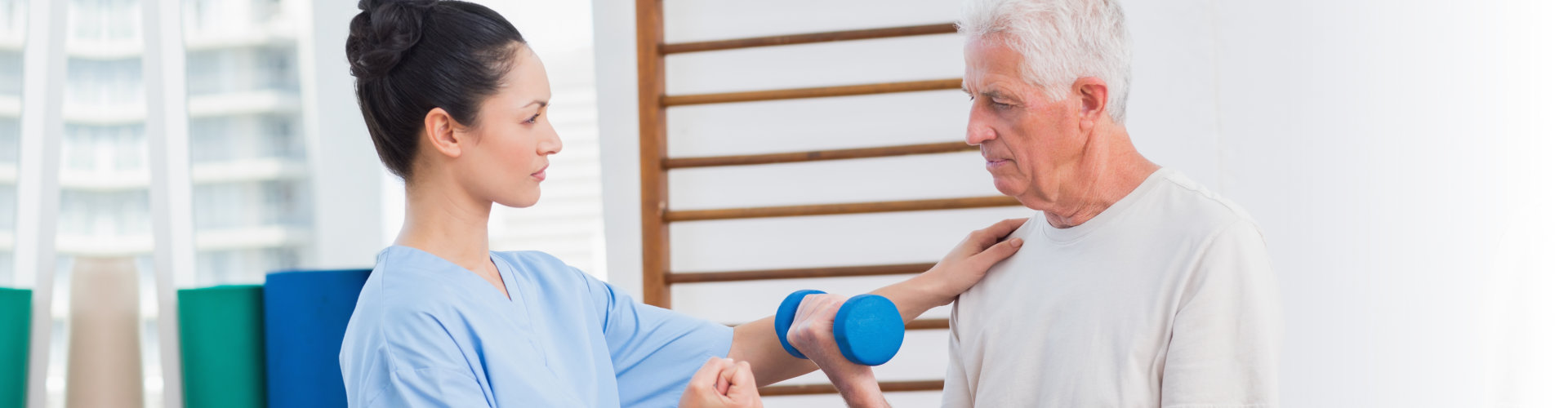 caregiver assisting the elder man doing exercise