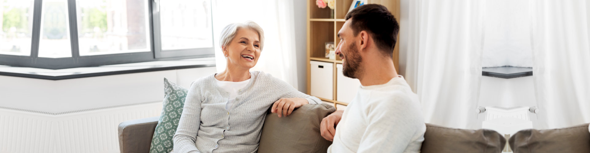 male caregiver and senior woman having a conversation