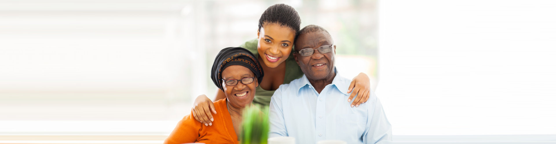 caregiver and senior couple are smiling